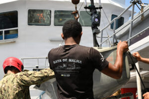 Cmdr. Michael Aragon with Task Force 66 and Seychelles Coast Guardsman Pvt. Thierry Cesar prepares for the launch of the Lightfish, an Unmanned Surface Vessel (USV), marking for the first time the system has been deployed from a partner surface ship, as part of Cutlass Express 2026 (CE 26). CE 26 is one of three regional Express series exercises sponsored by U.S. Africa Command and enabled by U.S. 6th Fleet as part of a comprehensive strategy to provide collaborative opportunities amongst African forces and international partners to address maritime security concerns.